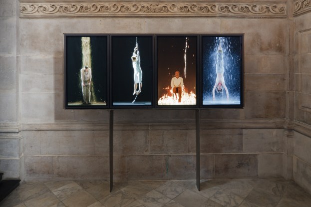 Photograph by Peter Mallet of a video installation by Bill Viola: Martyrs (Earth, Air, Fire, Water), 2014. Color high-definition video polyptych on four vertical plasma displays, 140 x 338 x 10 cm. St. Paul's Cathedral, London. Duration: 7:15 minutes.
